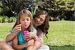 Mother and daughter enjoying making bubbles in the park