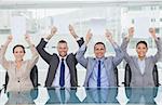 Smiling interview panel holding blank sheets above their head hiding the marks in bright office