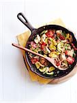 Overhead View of Chicken and Mushroom Ratatouille in Cast Iron Skillet with Wooden Spoon, Studio Shot