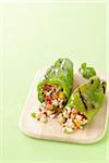 Grilled Green Peppers Stuffed with Israeli Couscous, Chickpeas and Vegetables on Cutting Board, Studio Shot