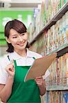 Sales Clerk Checking Groceries in Supermarket
