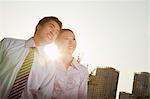 Portrait of two young business people leaning forward, close-up, brightly lit