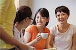 Four Friends sitting and talking in a coffee shop, Beijing