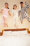 Family Jumping on Bed Together