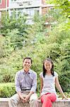 Father and Daughter Sitting in Courtyard