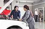 Mechanics and Customers in Auto Repair Shop