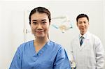 Portrait Of Smiling Female Dental Assistant In Clinic