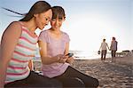 Mother and Daughter looking at camera on the beach