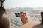 Young Woman Taking Photographs Outside Train Window