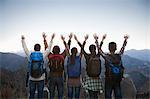 Group of people standing with hands outstretched