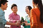 Friends Toasting Each Other on a Rooftop