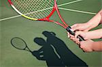 Shadow of mother and daughter playing tennis