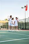 Family playing tennis, portrait