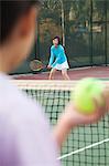 Mother and daughter playing tennis