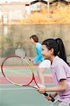 Mother and daughter playing tennis