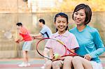 Mother and daughter playing tennis