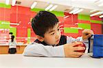 School boy checking lunch bag in school cafeteria