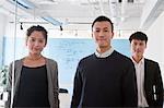 Coworkers in meeting room, portrait