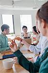 Coworkers eating and working in the cafeteria