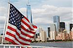 American Flag on Ferry with One World Trade Center and Skyline in Background, New York City, New York, USA