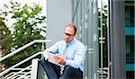 Businessman using Tablet Computer Outdoors, Mannheim, Baden-Wurttemberg, Germany