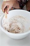 Close up of boy stirring dough in bowl