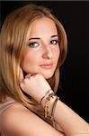 portrait of the beautiful young fair-haired woman with a bracelet on a hand