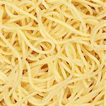 Cooked spaghetti pasta noodles forming a background with copyspace