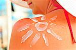 protective sun cream on a woman's shoulder