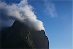 Silhouette of sharp mountain peak covered by cloud on Lofoten islands, Norway
