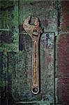 Old wrench on rusty surface sheet metal.