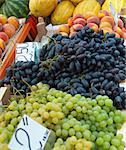 Fruits with prices on counter.