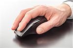 Male hand using a computer mouse.