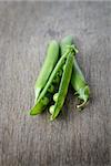 heap of fresh pea pods, on wood table