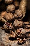 Cracked walnuts on rustic wooden table