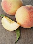 fresh peaches with lobule, on old wooden table