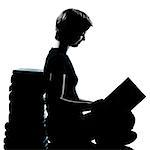 one caucasian young teenager silhouette boy or girl reading full length in studio cut out isolated on white background