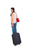 Beautiful traveling businesswoman carrying black travel suitcase and looking back over her shoulder on white background.