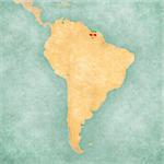 Suriname (Surinamese flag) on the map of South America. The Map is in vintage summer style and sunny mood. The map has a soft grunge and vintage atmosphere, which acts as a watercolor painting.