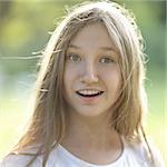 surprised teen girl outdoors, vertical portrait with backlight
