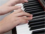 photo of girls hands playing on piano, shallow depth of field