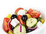 fresh greek salad in white bowl, white background