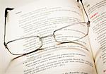 Pair of reading glasses on a dictionary