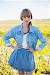 Trendy young woman posing in a sunny arid land