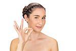 Cheerful woman making okay gesture on white background
