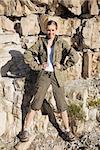 Athletic blonde on a hike posing in front of camera and smiling