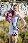 Active woman holding climbing equipment and looking at camera