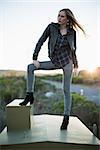 Stylish woman posing on top of a construction and looking away