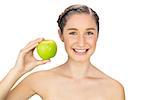 Cheerful healthy model holding green apple on white background