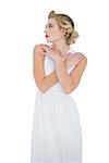 Pensive fashion blonde model posing looking away on white background